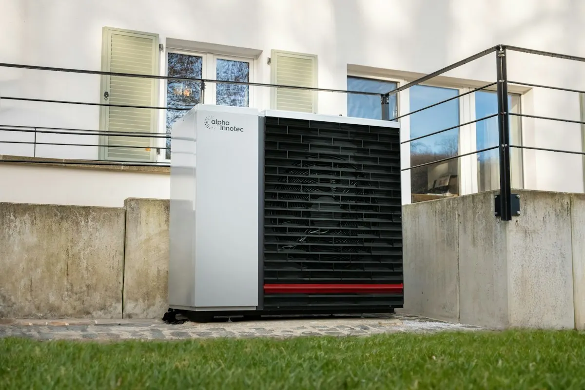 Outdoor heat-pump unit near a house balcony