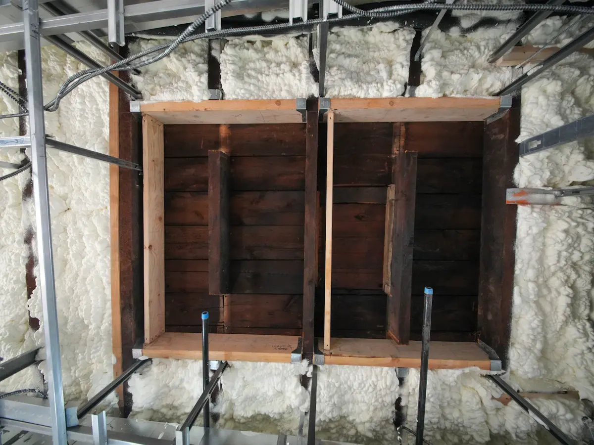 Exposed wall framing and insulation around a window opening