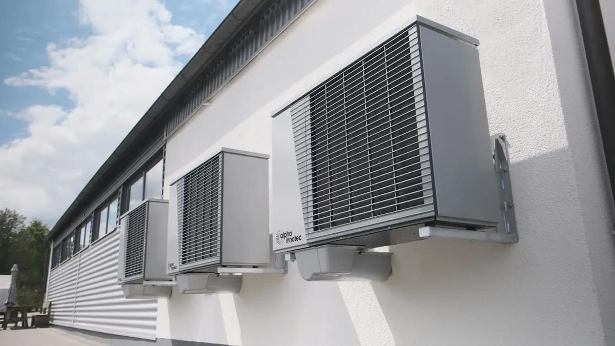 Wall-mounted outdoor cooling units on a white building